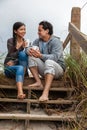 Asian Man Woman Romantic Couple on Beach Steps Drinking Coffee or Tea Royalty Free Stock Photo