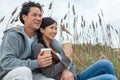 Asian Man Woman Romantic Couple Drinking Takeout Coffee on Beach