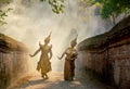 Asian man and woman wear Thai traditional dress and dance with beautifuul cultural style on the way with ancient wall and building Royalty Free Stock Photo