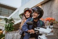 an asian man and woman wearing helmet riding a motorcycle Royalty Free Stock Photo