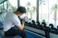 Asian man working out with DUMBBELL Weight Training at a resort fitness center in the morning Royalty Free Stock Photo