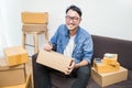 Asian man writing address on the box Royalty Free Stock Photo