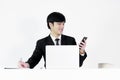 Asian manager businessman sitting at desk and using with phone, Royalty Free Stock Photo