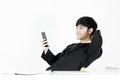 Asian manager businessman sitting at desk and using with phone, Royalty Free Stock Photo