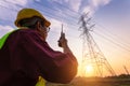 Asian Manager Engineering in standard safety uniform working inspect the electricity high voltage pole Royalty Free Stock Photo