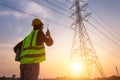 Asian Manager Engineering in standard safety uniform working inspect the electricity high voltage pole