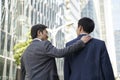 Asian manager giving partner a pat on the back Royalty Free Stock Photo