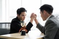 Asian mans with arm wrestle with trophy competition / business competition / winner