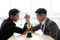 Asian mans with arm wrestle with trophy competition / business competition / winner Royalty Free Stock Photo