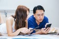 Asian mature couple look at smartphone and booking hotel for holidays trip Royalty Free Stock Photo
