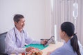 Asian mature male doctor. Smiling, Doctors giving a consultation Explain the medical to patient Royalty Free Stock Photo