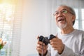 Asian mature man hands using game controller play videogame Royalty Free Stock Photo