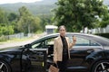 Asian mature woman disembarking the luxury car Royalty Free Stock Photo