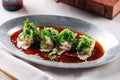 Asian meat stuffed dumplings with sauce in a bowl