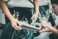 Asian mechanic man fixing the retro motorcycle in the garage. Film effected - Selective focused