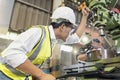 Asian mechanical engineer operating industrial lathe machine. Technicians and engineers are working on industrial machines Royalty Free Stock Photo