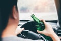 Asian men are breaking the traffic rules by holding a bottle of beer and drinking while driving Royalty Free Stock Photo