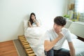 Asian man depresses and woman with unhappy relationship sit on bed after have an argument,social problem in couple live Royalty Free Stock Photo