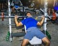 Asian men exercise chest workout on bench press machine lifestyle of Royalty Free Stock Photo