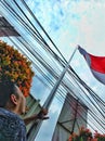 Asian men fly the red and white flag on Indonesian Independence Day at noon with blue skies