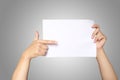 Asian men hands holding the white blank paper isolated on grey white background Royalty Free Stock Photo