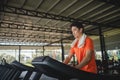 Asian men are happy jogging and running on a treadmill at gym. A man is jogging and doing cardio training. Healthy lifestyle Royalty Free Stock Photo