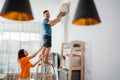 asian man install airconditioner with partner Royalty Free Stock Photo