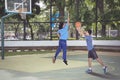 Asian men playing basketball together actively Royalty Free Stock Photo