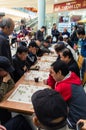 Asian men playing Chinese chess in a shopping centre in Springvale, Melbourne Royalty Free Stock Photo