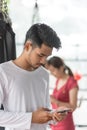 Asian men are playing mobile phones in the gym Royalty Free Stock Photo