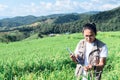 Asian men are recording data of rice plants in fields