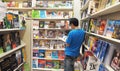 Asian men stand reading books on comput