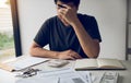 Asian men are stressed about financial problems, with invoices and calculators placed on the table while having stress on problems Royalty Free Stock Photo