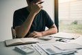 Asian men are stressed about financial problems, with invoices and calculators placed on the table while having stress on problems Royalty Free Stock Photo