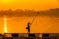 Asian men are using nets to fish in the Mekong River. Fishermen raising nile tilapia, floating cages on the Mekong River. Nongkhai