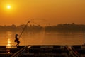 Asian men are using nets to fish in the Mekong River. Fishermen raising nile tilapia, floating cages on the Mekong River. Nongkhai