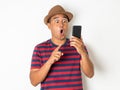 Asian men are using smartphones. He looks at the phone Then made a very surprised face. He is around 27-35 years old. He wears red Royalty Free Stock Photo