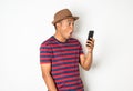 Asian men are using smartphones. He looks at the phone Then made a very surprised face. He is around 27-35 years old. He wears red Royalty Free Stock Photo