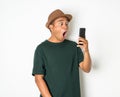 Asian men are using smartphones. He looks at the phone Then made a very surprised face He wears an old green shirt and wears a Royalty Free Stock Photo