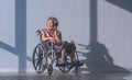 Asian mental healthy elderly woman on wheelchair smiling and talking on mobile phone in rest area at hospital Royalty Free Stock Photo