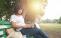 Asian mid aged woman using laptop in park Royalty Free Stock Photo