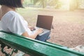 Asian mid aged woman using laptop in park Royalty Free Stock Photo