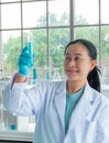 Asian middle-age woman scientists. Smiling, are working test tube make research