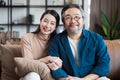 Asian Middle-aged Asian couple smiling at the camera. Family couple portrait. Royalty Free Stock Photo