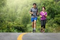 Asian middle aged couple jogging exercise in park