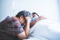 Asian middle-aged husband Stressed and upset by his wife`s illness Lying in a patient`s bed