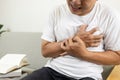 Asian middle-aged man clutching chest pain,difficulty breathing suffer from heart attack,angina pectoris disease,heart and Royalty Free Stock Photo