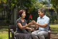 Asian middle-aged man gives a rose to his wife in valentine day Royalty Free Stock Photo