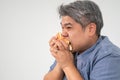 Asian Middle aged man holds and eating a hamburger deliciously Concept of binge eating disorder BED and Relaxing with Eating Royalty Free Stock Photo