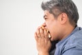 Asian Middle aged man holds and eating a hamburger deliciously Concept of binge eating disorder BED and Relaxing with Eating Royalty Free Stock Photo